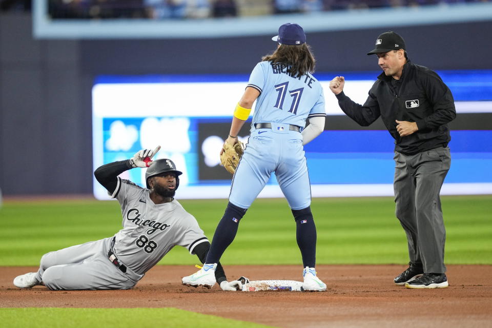 Chicago White Sox's Luis Robert Jr. (88) reacts after being tagged out by Toronto Blue Jays shortstop Bo Bichette (11) at second base during the first inning of a baseball game in Toronto, Wednesday, April 26, 2023. (Andrew Lahodynskyj/The Canadian Press via AP)