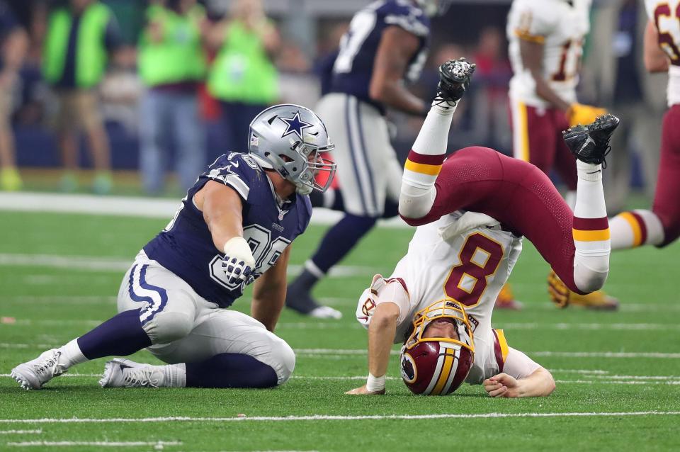 ARLINGTON, TX - NOVEMBER 24:   Kirk Cousins #8 of the Washington Redskins takes a hit from Tyrone Crawford #98 of the Dallas Cowboys during the second quarter of their game at AT&T Stadium on November 24, 2016 in Arlington, Texas.  (Photo by Tom Pennington/Getty Images)