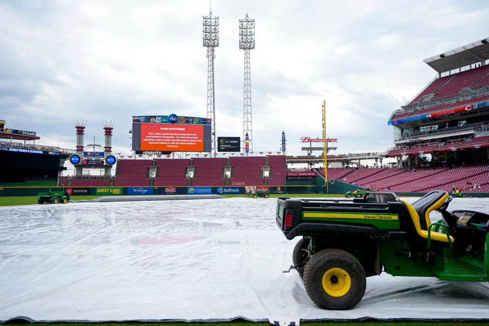An official postponement is announced before the first inning of the MLB National League game between the Cincinnati Reds and the Chicago Cubs at Great American Ball Park in downtown Cincinnati on Wednesday, April 5, 2023.