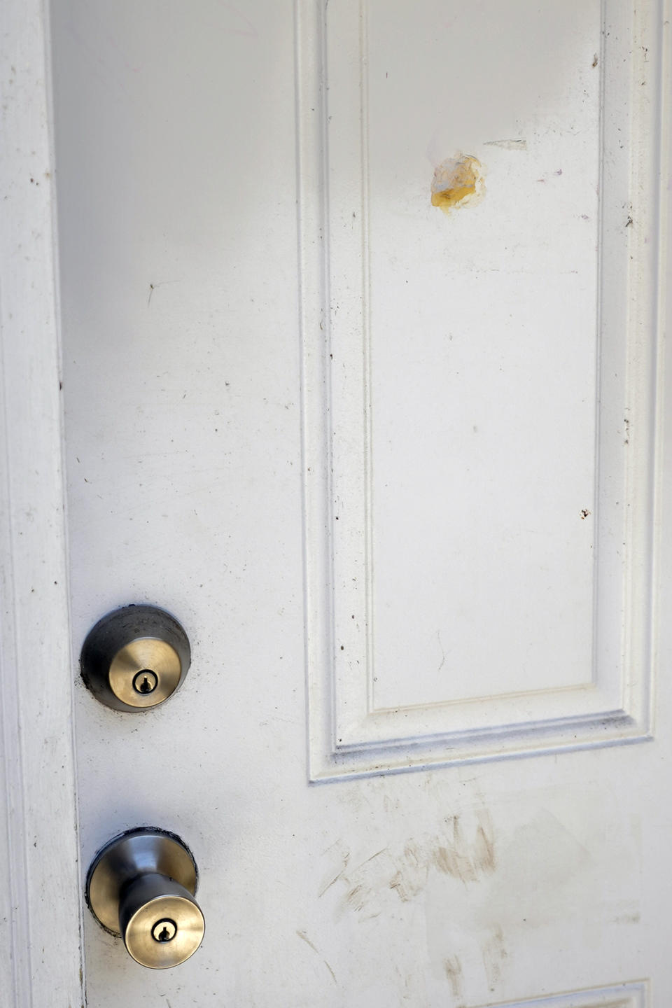A patched bullet hole, upper right, is seen on a door, Tuesday, June 6, 2023, where Ajike Owens, a 35-year-old mother of four, was shot and killed the week before, moments after going to the apartment of her neighbor who had yelled at Owens' children as they played in a nearby lot, in Ocala, Fla. (AP Photo/John Raoux)