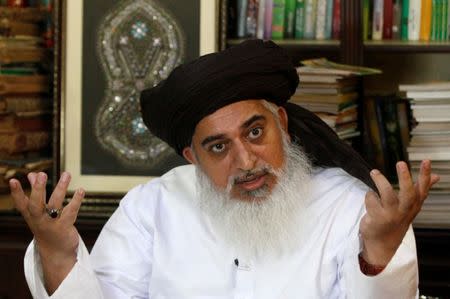 Khadim Hussain Rizvi, leader of Tehrik-e-Labaik Pakistan Islamist political party gestures during an interview with Reuters in Lahore, Pakistan July 14, 2018. Picture taken July 14, 2018. REUTERS/Mohsin Raza