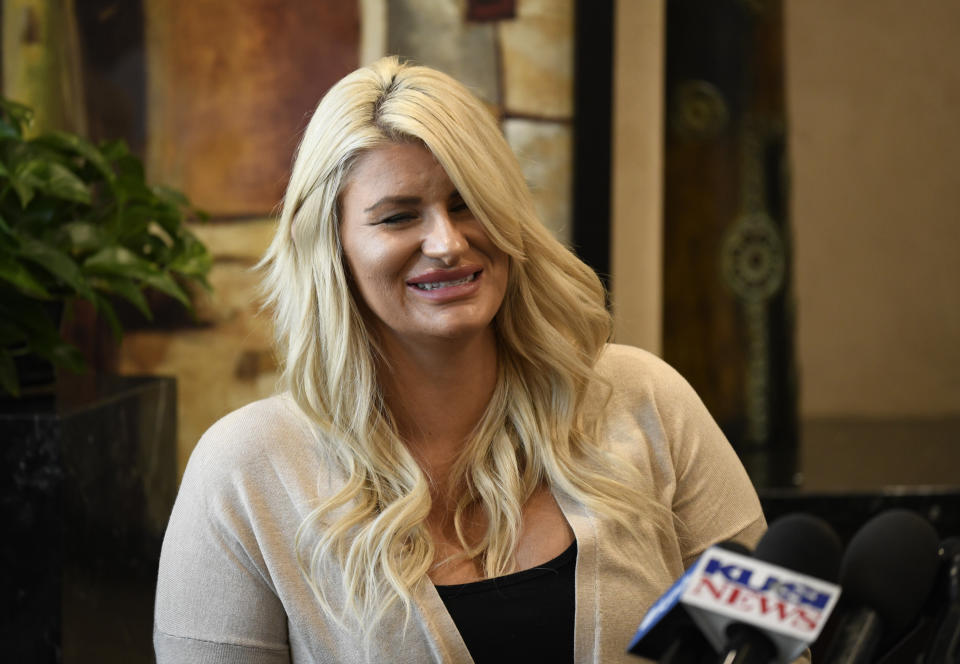 Chelsea Romo reacts as she recounts some of the details of the the Las Vegas Shooting at a news conference, Thursday, Oct. 3, 2019, in San Diego. Romo lost her left eye in the Las Vegas shooting. Two years after a shooter rained gunfire on country music fans from a high-rise Las Vegas hotel, MGM Resorts International reached a settlement that could pay up to $800 million to families of the 58 people who died and hundreds of others who were injured, attorneys announced Thursday. (AP Photo/Denis Poroy)