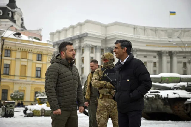 Prime Minister Rishi Sunak, speaking with Ukraine President Volodymyr Zelensky as they look at destroyed Russian military vehicles in Kyiv, Ukraine (PA)