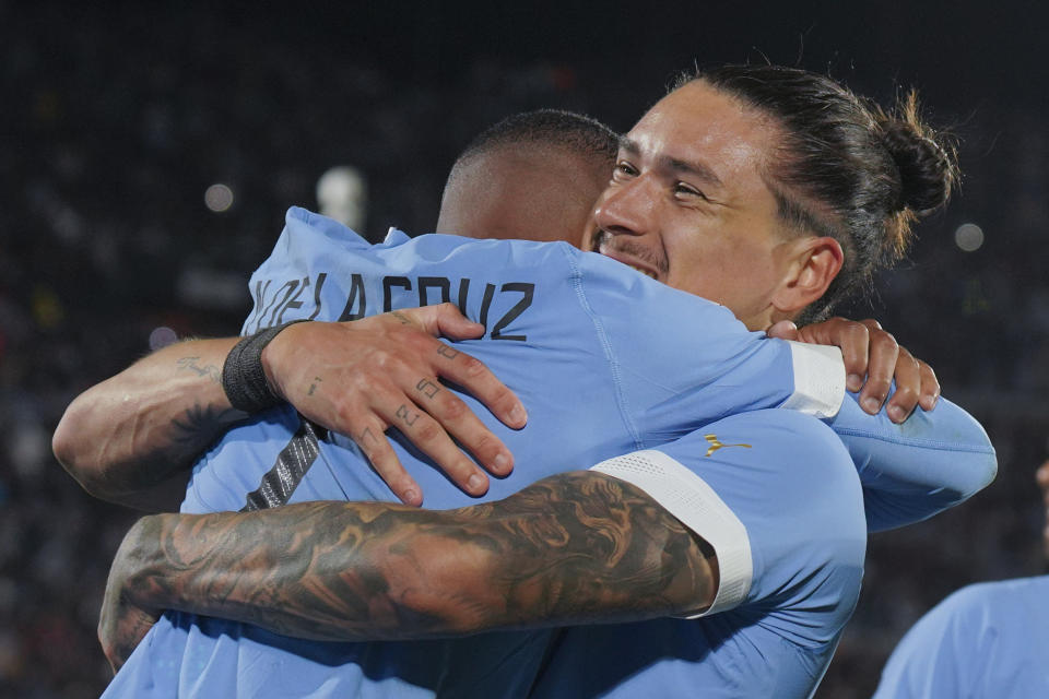 Uruguay's Nicolas De La Cruz, left, is congratulated by teammate Darwin Nunez after scoring his side's 2nd goal against Brazil during a qualifying soccer match for the FIFA World Cup 2026 at Centenario stadium in Montevideo, Uruguay, Tuesday, Oct. 17, 2023. (AP Photo/Matilde Campodonico)