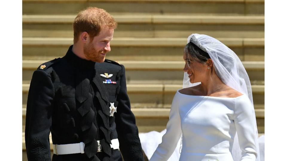 Prince Harry smiles at his new wife the Duchess of Sussex on the steps of St George's Chapel