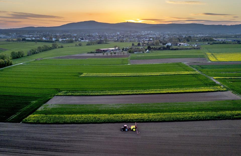 FILE - A farmer fertilizes a field in the outskirts of Frankfurt, Germany, April 26, 2023. The European Union has been at the forefront of the fight against climate change and the protection of nature for years. But it now finds itself under pressure from within to pause new environmental efforts amid fears they will hurt the economy. (AP Photo/Michael Probst, File)