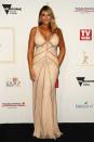 <p>Fiona Falkiner could have been mistaken for a gold Logie in this glittering gold Rachel Gilbert gown which showed off her incredible figure.</p>