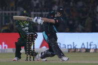 New Zealand's Mark Chapman plays a shot during the fifth T20 international cricket match between Pakistan and New Zealand, in Lahore, Pakistan, Saturday, April 27, 2024. (AP Photo/K.M. Chaudary)