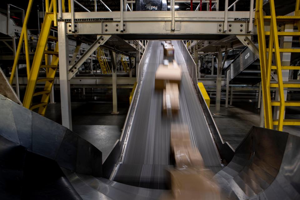 Packages move along a conveyor belt Wednesday, Dec. 4, 2019, at the FedEx Ground Olive Branch hub.