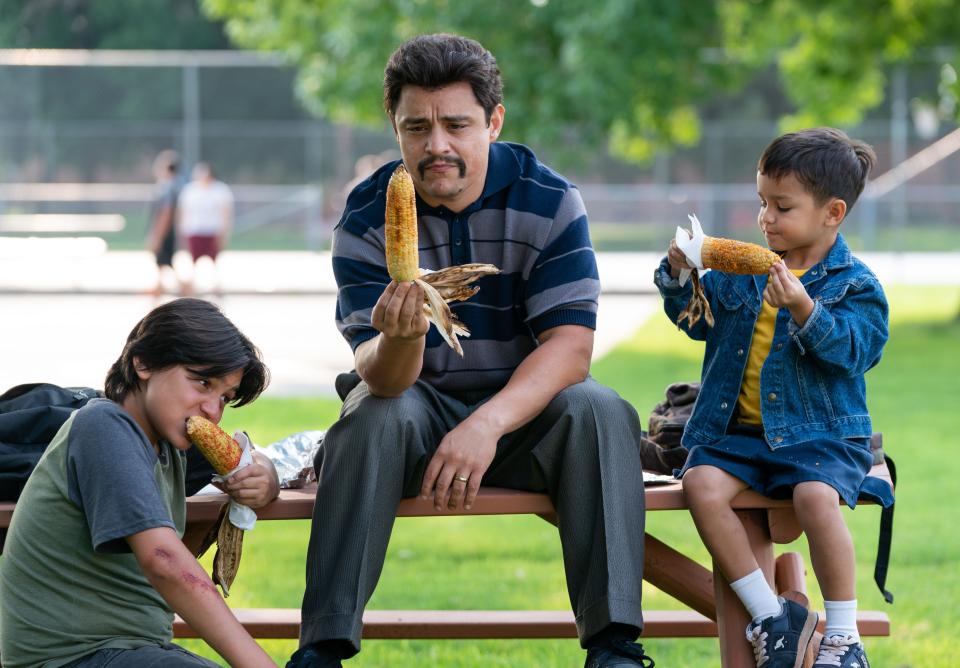 Richard Montañez (Jesse Garcia) and his two sons, Lucky and Steven (Hunter Jones, left, and Brice Gonzalez), eat spicy corn on the cob at the park before the idea for Flamin' Hot Cheetos was sparked.