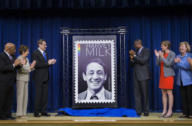 <p>JIM WATSON/AFP/Getty</p> Ronald Stroman and Stuart Milk unveil the Harvey Milk Forever stamp during a ceremony in Old Executive Office Building in Washington, DC on May 22, 2014.