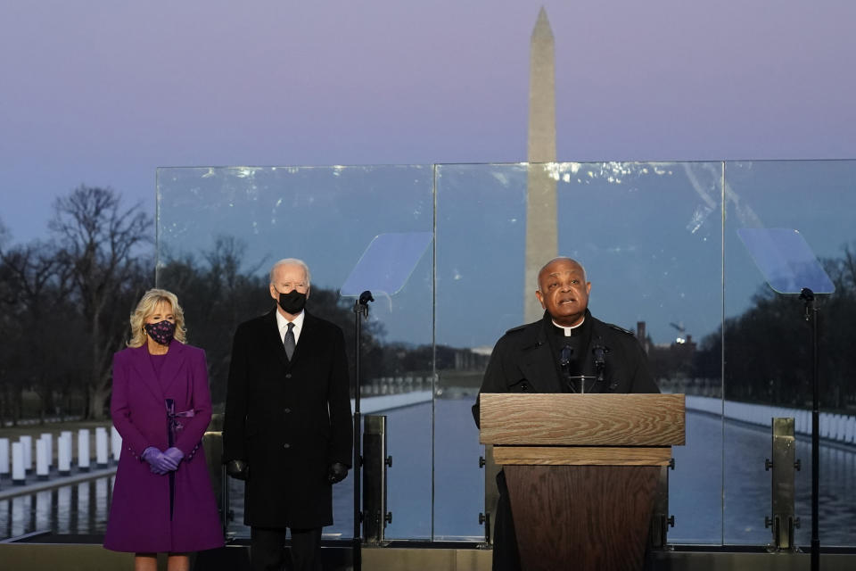 FILE - In this Tuesday, Jan. 19, 2021 file photo, President-elect Joe Biden and his wife, Jill, listen as Cardinal Wilton Gregory, Archbishop of Washington, delivers the invocation during a COVID-19 memorial at the Lincoln Memorial Reflecting Pool in Washington. Gregory has made clear that President Biden, who sometimes worships in Washington, is welcome to receive Communion at the archdiocese's churches. (AP Photo/Alex Brandon, File)