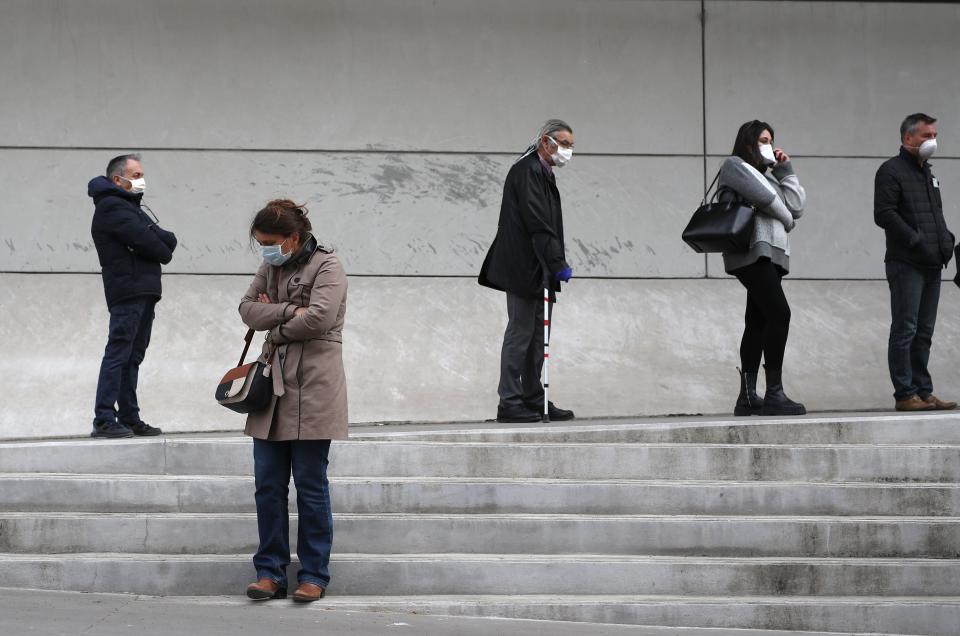 People wait in line to get a coronavirus test outside the La Timone hospital in Marseille, France, March 23, 2020.