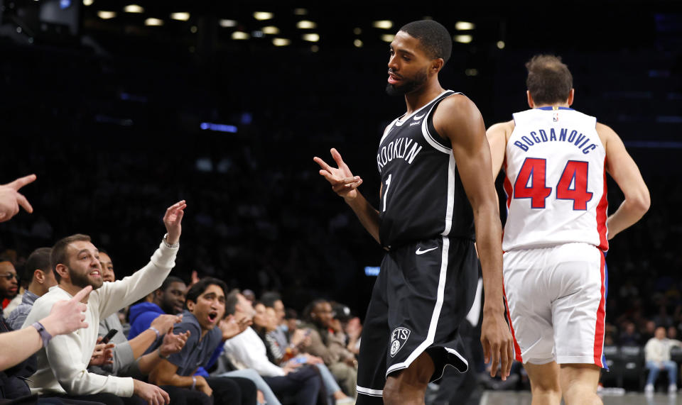 Brooklyn Nets forward Mikal Bridges (1) reacts after making a 3-point shot against Detroit Pistons forward Bojan Bogdanovic (44) during the first half of an NBA basketball game Saturday, Dec. 23, 2023, in New York. (AP Photo/Noah K. Murray)