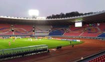 In this photo provided by the Korea Football Association, South and North Korean, wearing red uniforms, players play during their Asian zone Group H qualifying soccer match for the 2022 World Cup at Kim Il Sung Stadium in Pyongyang, North Korea, Tuesday, Oct. 15, 2019. South Korea soccer officials say they can't see a telecast of the historic World Cup qualifier in Pyongyang between their national team and North Korea, and think the game was proceeding at an empty Kim Il Sung Stadium. (The Korea Football Association via AP)