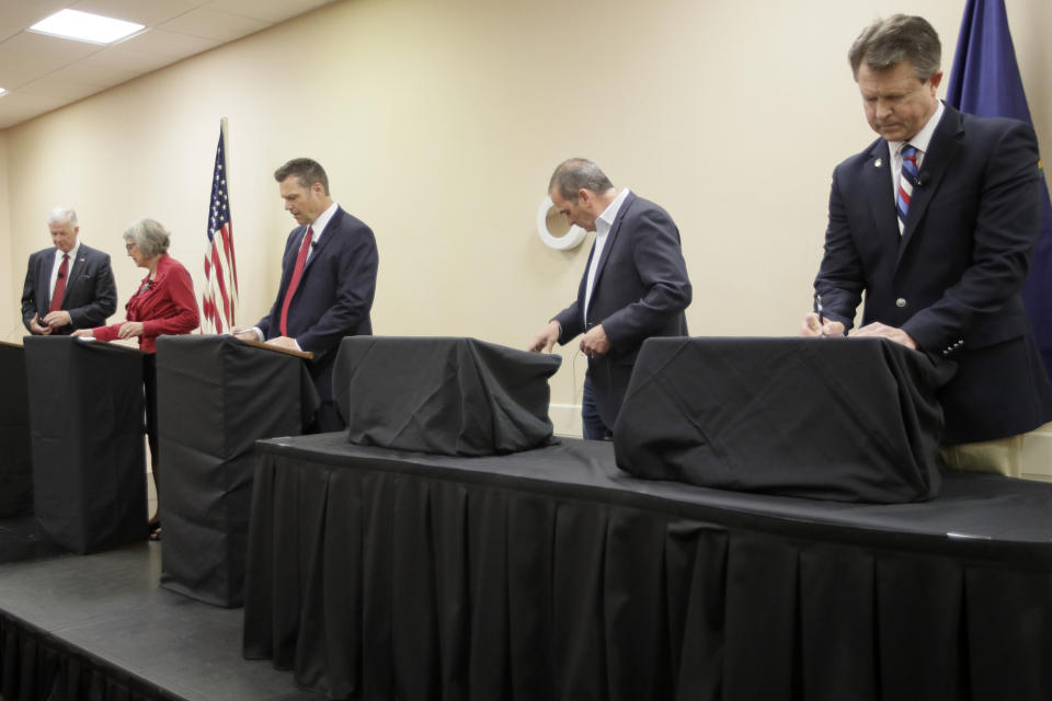 Senate candidates prepare for a GOP senatorial debate In Manhattan, Kan., Saturday, May 23, 2020. David Lindstrom, left, Susan Wagle, second from left, Kris Kobach, middle, Bob Hamilton, second from right, and Dr. Roger Marshall, right, occupy the debate stage. (AP Photo/Orlin Wagner)
