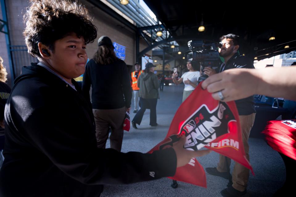 El Paso Chihuahuas fans receive a towel as they enter the Southwest University Park in El Paso, Texas, for the opening day against Round Rock on Tuesday, April 2, 2024.