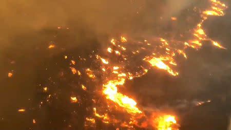 An aerial view showing the Woolsey Fire in Malibu, California, U.S. is seen in this still image obtained via from a November 9, 2018 social media video. Michael Dubron/TWITTER