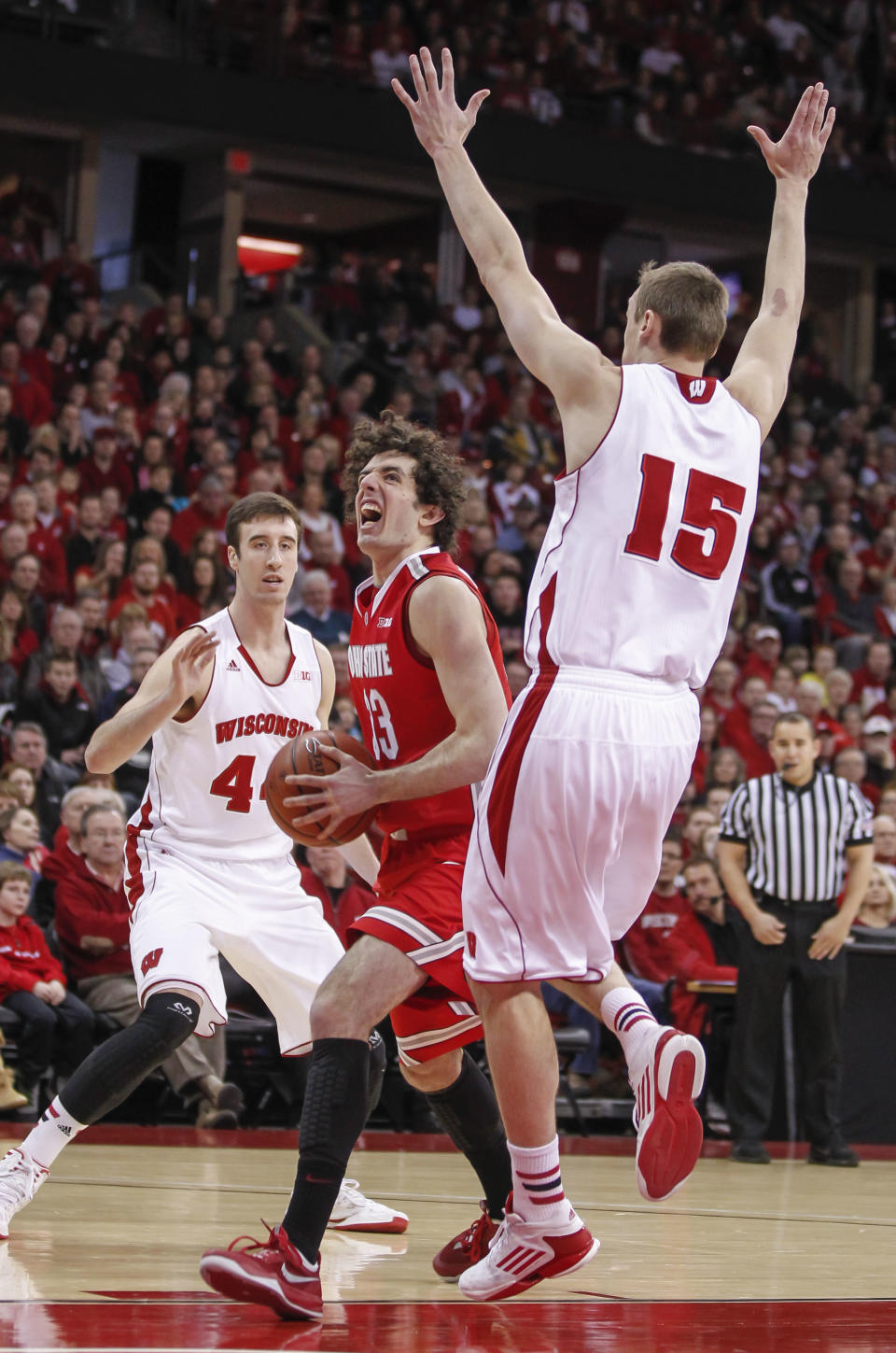 Ohio State's Amedeo Della Valle, center, shoots between Wisconsin's Frank Kaminsky, left, and Sam Dekker (15) during the first half of an NCAA college basketball game Saturday, Feb. 1, 2014, in Madison, Wis. (AP Photo/Andy Manis)