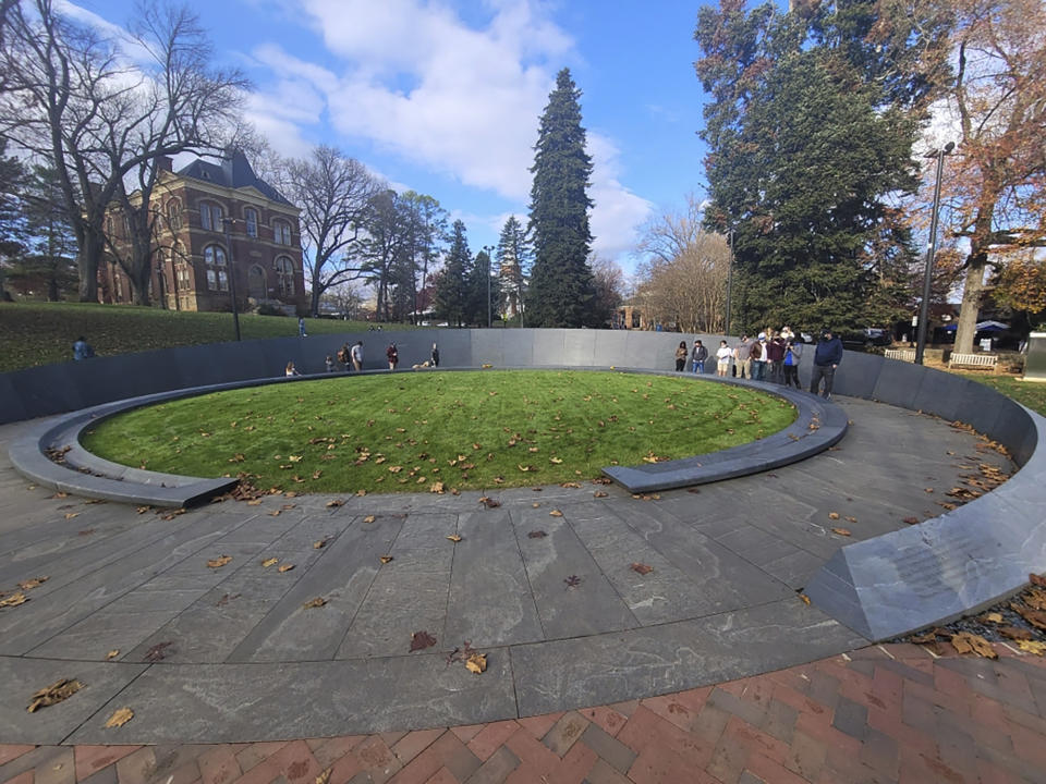 Visitors walk around the recently completed Memorial to Enslaved Laborers at the University of Virginia in Charlottesville in November 2020. The memorial is a tribute to the enslaved people whose work building and maintaining the school founded by Thomas Jefferson had long gone unrecognized. Devon Henry's Virginia construction company completed over 350 projects in 2020 but this one, he said, was the most meaningful by far. Henry, a Black man who faced death threats after it came to light that his company also handled this year's removal of Richmond's Confederate monuments, took his family to visit the Charlottesville site in November. He snapped this shot, which he said more than anything else, exemplifies 2020 for him. "This was a year, for me, of reflection," he said. (Devon Henry via AP)