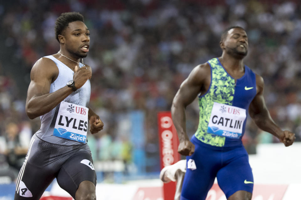 Noah Lyles from the USA and Justin Gatlin from the USA, from left, compete in the men's 100m race, during the Weltklasse IAAF Diamond League international athletics meeting in the stadium Letzigrund in Zurich, Switzerland, Thursday, August 29, 2019. (Jean-Christophe Bott/Keystone via AP)