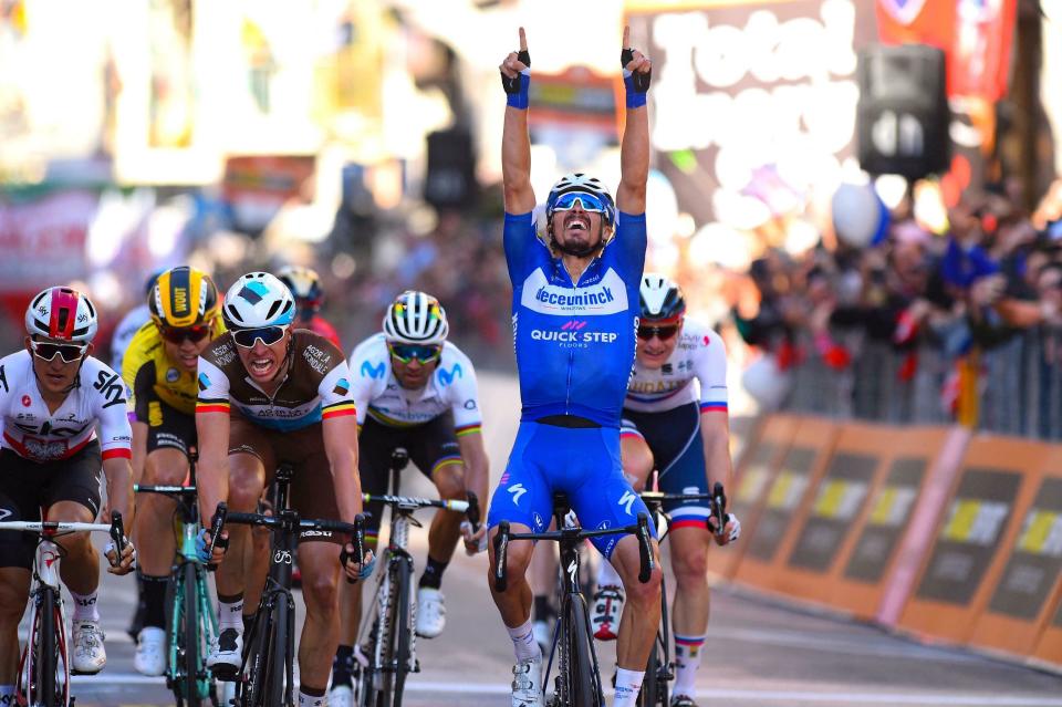 French rider Julian Alaphilippe, right, celebrates as he crosses the finish line to win, as Oliver Naesen, at his left, of AG2R, comes in second, and Michal Kwiatkowski of Team Sky, left, third, after a 10-man sprint at the end of the 291-kilometer (181-mile) route along the Italian Riviera for the 110th edition of the Milano-Sanremo cycling classic, in Sanremo, Italy, Saturday, March 23, 2019. (Dario Belinghieri/ANSA via AP)