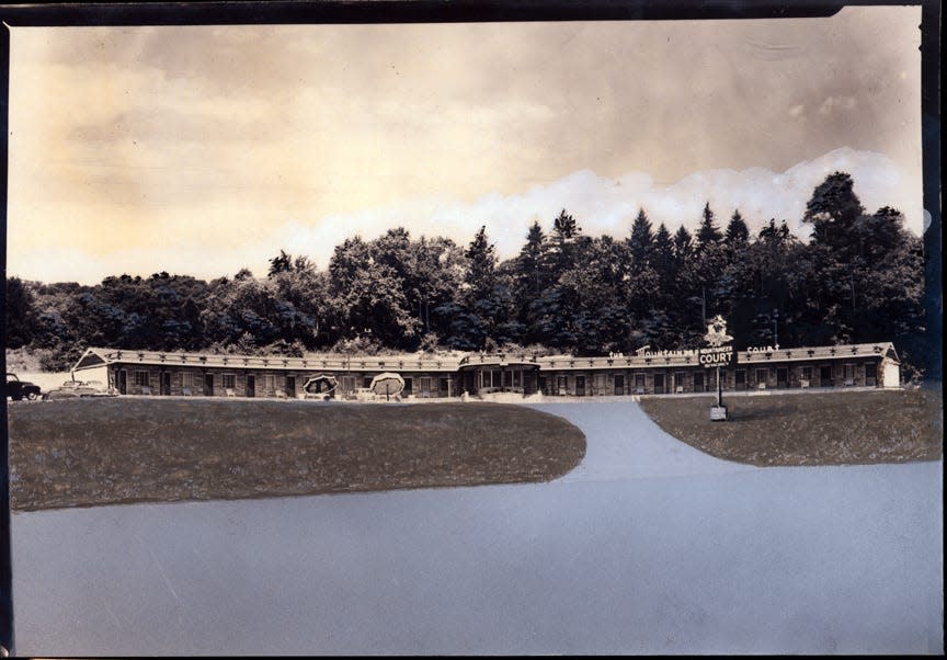 A postcard featuring a broad view of The Mountaineer Court. The print was retouched for use by Asheville Post Card Co.