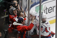 Washington Capitals fans celebrate with Jakub Vrana (13) and Michal Kempny (6) after Vrana scored a goal during the third period of an NHL hockey game against the New York Islanders Saturday, Jan. 18, 2020, in Uniondale, N.Y. The Capitals won 6-4. (AP Photo/Frank Franklin II)