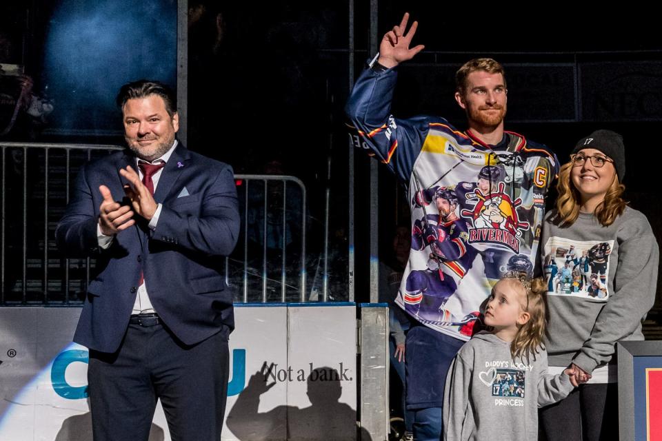 Peoria Rivermen captain Alec Hagaman waves goodbye to the fans, with his wife, Emily, and daughter, Adley, and head coach Jean-Guy Trudel at his side during a retirement tribute to the player before the 2022-23 regular-season finale at Carver Arena on Saturday, April 8, 2023.