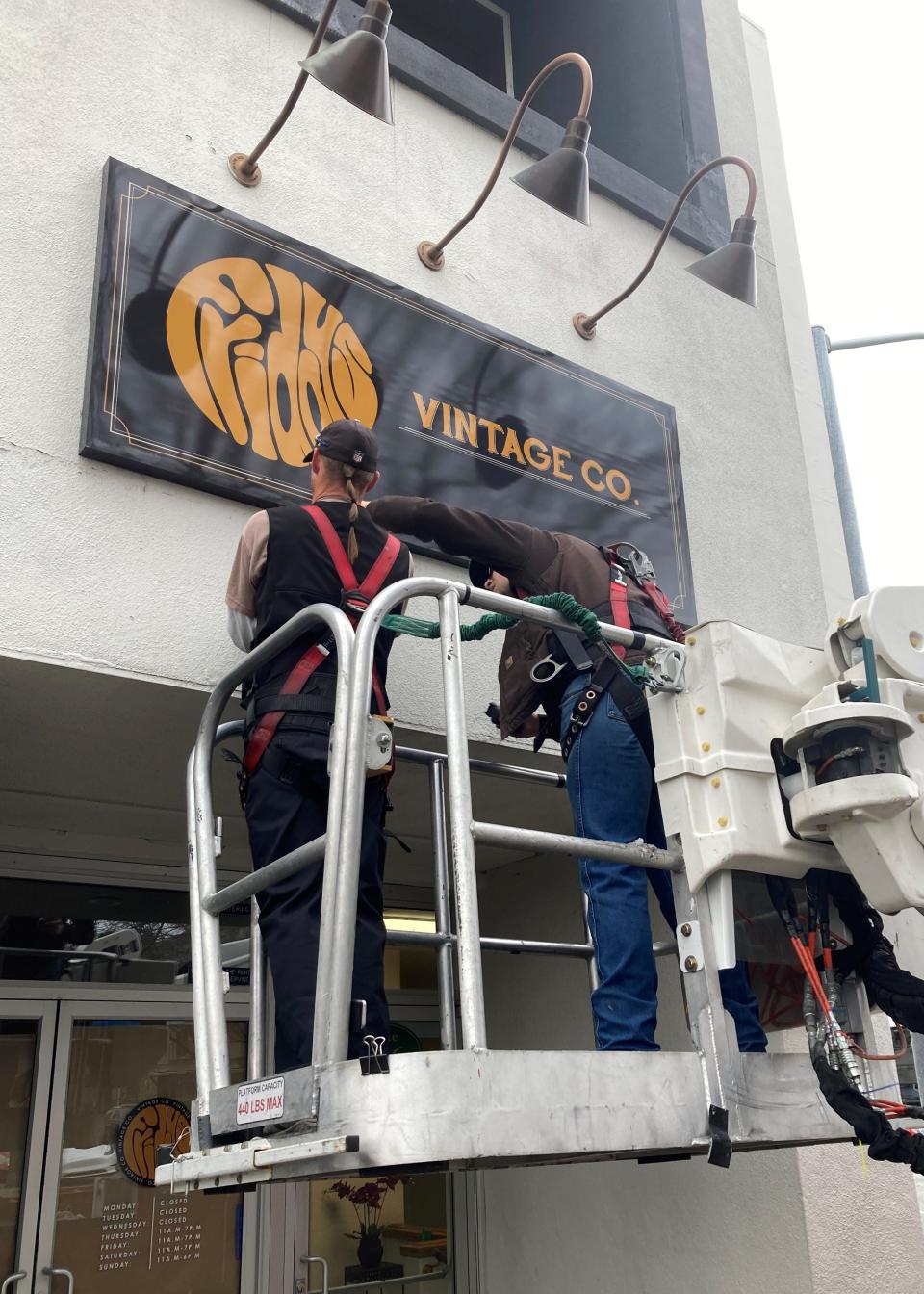 Workers with Signarama put up the new Friday's Vintage sign in downtown Redding on Friday, Feb. 10, 2023.