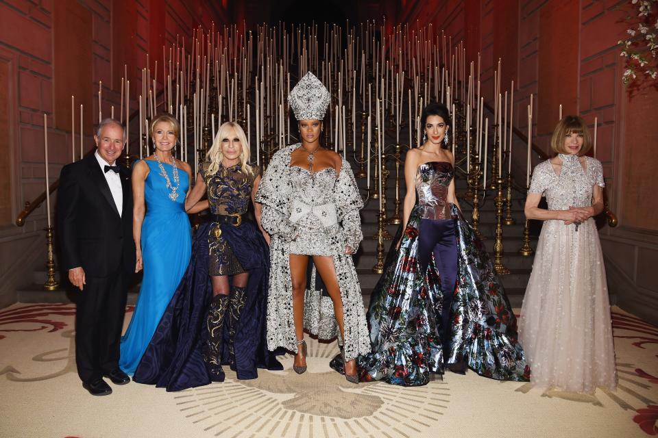 The 2018 Met Gala chairs pose on the red carpet, including Stephen Schwarzman, Christine Schwarzman, Donatella Versace, Rihanna, Amal Clooney, and Anna Wintour.