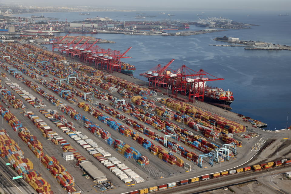 Shipping containers are unloaded from ships at a container terminal at the Port of Long Beach-Port of Los Angeles complex, amid the coronavirus disease (COVID-19) pandemic, in Los Angeles, California, U.S., April 7, 2021. REUTERS/Lucy Nicholson