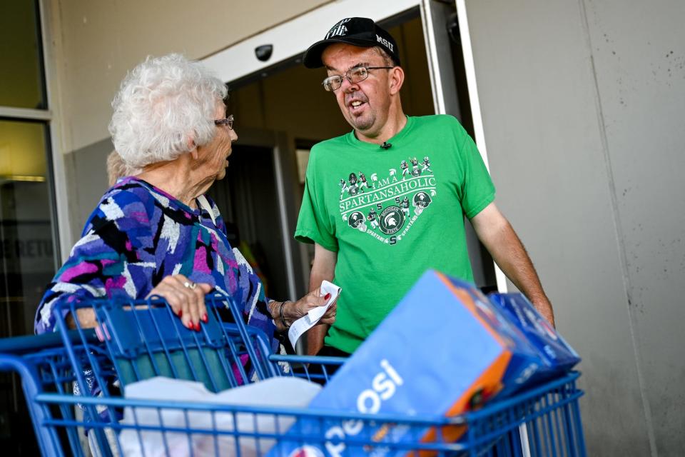 Dave Esch, right, talks with customer Sandie Johnston during Esch's celebration on Wednesday, July 20, 2022, at the Meijer in Grand Ledge. Esch was honored for returning his millionth shopping cart as an employee of the store.
