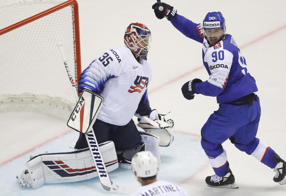 Slovakia's Tomas Tatar, right, celebrates his sides fourth goal past goaltender Cory Schneider of the US, left, during the Ice Hockey World Championships group A match between Slovakia and the United States at the Steel Arena in Kosice, Slovakia, Friday, May 10, 2019. (AP Photo/Petr David Josek)