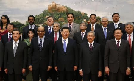 China's President Xi Jinping (front C) poses for photos with guests at the Asian Infrastructure Investment Bank launch ceremony at the Great Hall of the People in Beijing October 24, 2014. REUTERS/Takaki Yajima/Pool