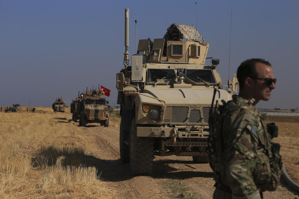 Turkish and American armored vehicles patrol as they conduct joint ground patrol in the so-called "safe zone" on the Syrian side of the border with Turkey, near the town of Tal Abyad, northeastern Syria, Friday, Oct.4, 2019. The patrols are part of a deal reached between Turkey and the United States to ease tensions between the allies over the presence of U.S.-backed Syrian Kurdish fighters in the area. (AP Photo/Baderkhan Ahmad)