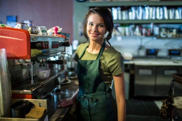 Portrait of teenage waitress in coffee house