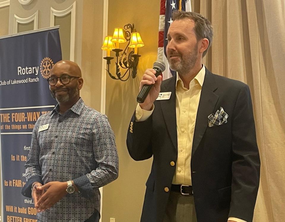 The Players artistic director Steven Butler, left, and CEO William Skaggs encourage people to get involved in community theater while accepting a Rotary grant that funds two defibrillators for their facilities.