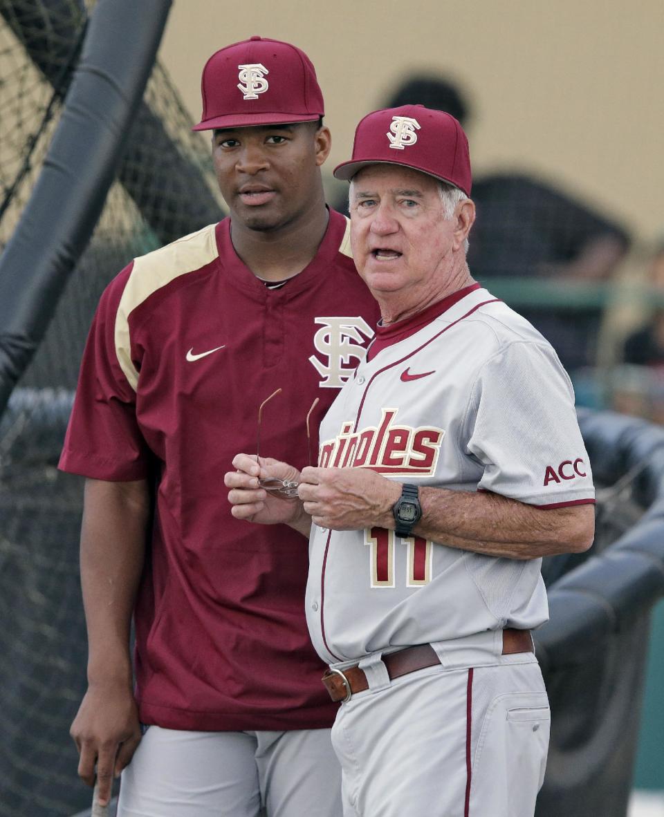 Florida State head coach Mike Martin, right, talks to pitcher Jameis Winston before an NCAA college baseball game against South Florida Tuesday, March 4, 2014, in Tampa, Fla. (AP Photo/Chris O'Meara)