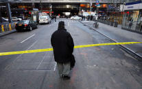 A passer-by looks over the police tape outside the New York Port Authority Bus Terminal in New York City, U.S. December 11, 2017 after reports of an explosion. REUTERS/Brendan McDermid