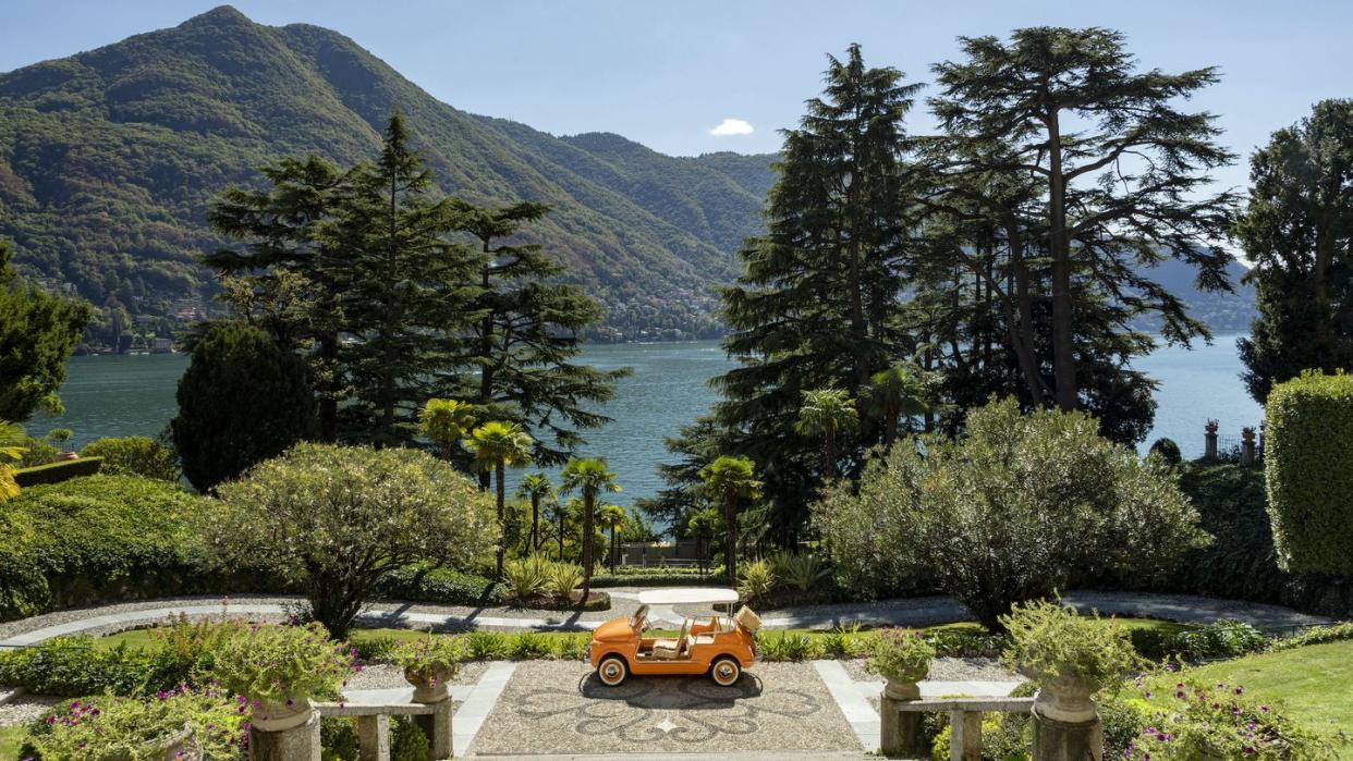 a yellow car parked in a garden