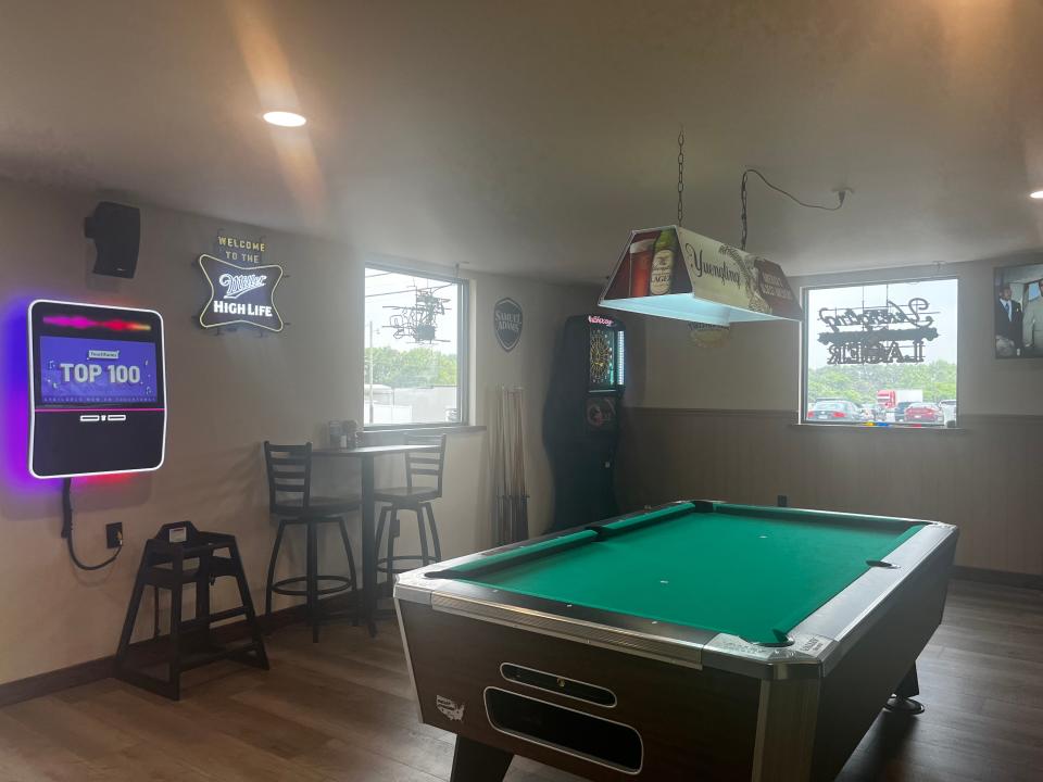 A pool table, dart board and juke box were put in the restaurant