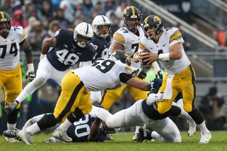 Oct 27, 2018; University Park, PA, USA; Iowa Hawkeyes quarterback Nate Stanley (4) runs the ball during the second quarter against the Penn State Nittany Lions at Beaver Stadium. Mandatory Credit: Matthew O'Haren-USA TODAY Sports
