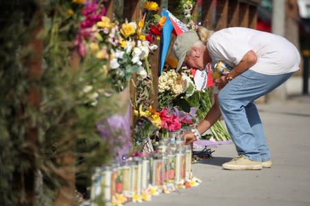 Jennifer Stafford attends to a makeshift memorial near Truth Aquatics as the search continues for those missing in a pre-dawn fire that sank a commercial diving boat off Santa Barbara, California