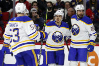 Buffalo Sabres' Jacob Bryson (78), Jeff Skinner (53) celebrate with Alex Tuch (89), who scored during the first period of the team's NHL hockey game against the Carolina Hurricanes in Raleigh, N.C., Thursday, April 7, 2022. (AP Photo/Karl B DeBlaker)