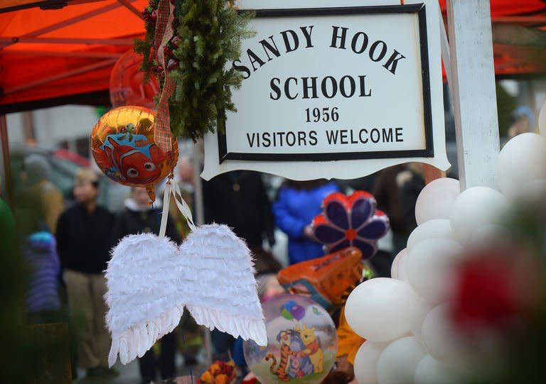 A pair of angel wings and balloons are left at a makeshift shrine to the victims of a elementary school shooting in Newtown, Connecticut, December 16, 2012. Nine-year-old Nicholas Sabillon was remarkably composed as he recounted how the Connecticut gunman who killed his schoolmates pounded on the locked door of the room where he was hiding