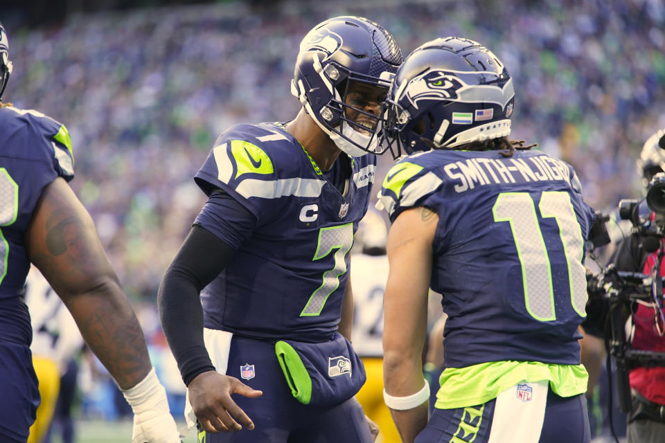 Seattle Seahawks quarterback Geno Smith (7) celebrates with wide receiver Jaxon Smith-Njigba (11) after they combined for a touchdown pass against the Pittsburgh Steelers in the first half of an NFL football game Sunday, Dec. 31, 2023, in Seattle. (AP Photo/Lindsey Wasson)