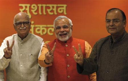 (From L - R) India's main opposition Hindu-nationalist Bharatiya Janata Party (BJP) leader Lal Krishna Advani, Gujarat's chief minister and Hindu nationalist Narendra Modi, the prime ministerial candidate for BJP and leader Arun Jaitley show victory signs before their meeting in New Delhi December 8, 2013. REUTERS/Ahmad Masood/Files