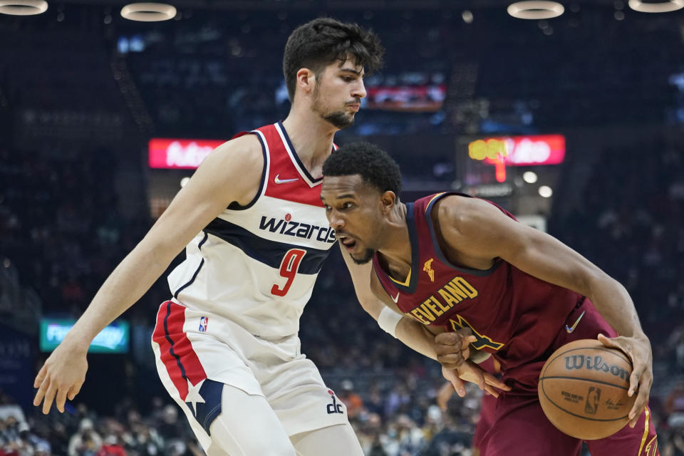 Cleveland Cavaliers' Evan Mobley (4) drives against Washington Wizards' Deni Avdija (9) in the first half of an NBA basketball game, Wednesday, Nov. 10, 2021, in Cleveland. (AP Photo/Tony Dejak)