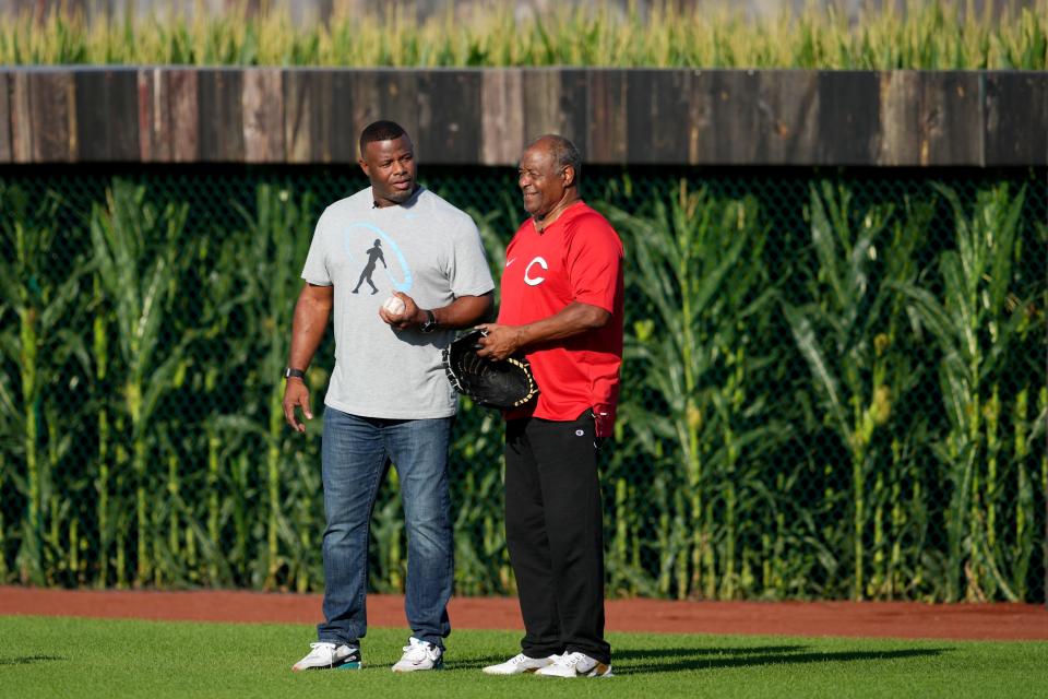 Hall of Fame baseball player and former Cincinnati Reds center fielder Ken Griffey Jr., left, asks his dad and fellow  Hall of Fame player Ken Griffey Sr., if heÕd like to play catch  before a baseball game between the Chicago Cubs and the Cincinnati Reds, Thursday, Aug. 11, 2022, at the MLB Field of Dreams stadium in Dyersville, Iowa. 